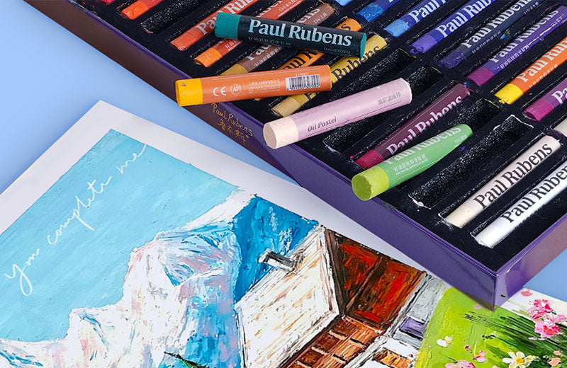 An exquisite box of Paul Rubens oil pastels, next to the oil paintings it produces.